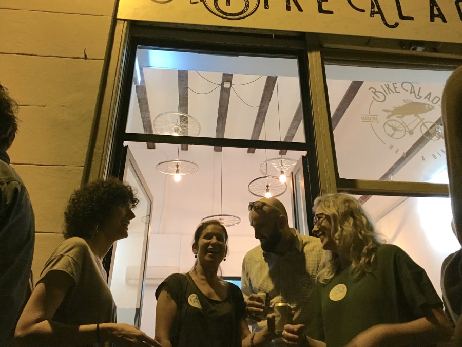 Customers enjoying a beer outside the shop
